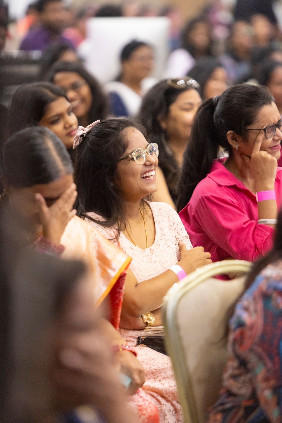Women laughing together in sisterhood at a church gathering